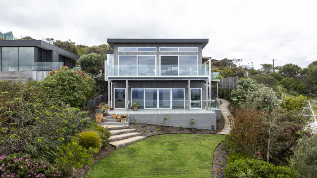 Completed exterior facade of a luxury custom coastal home in surf coast featuring natural timber